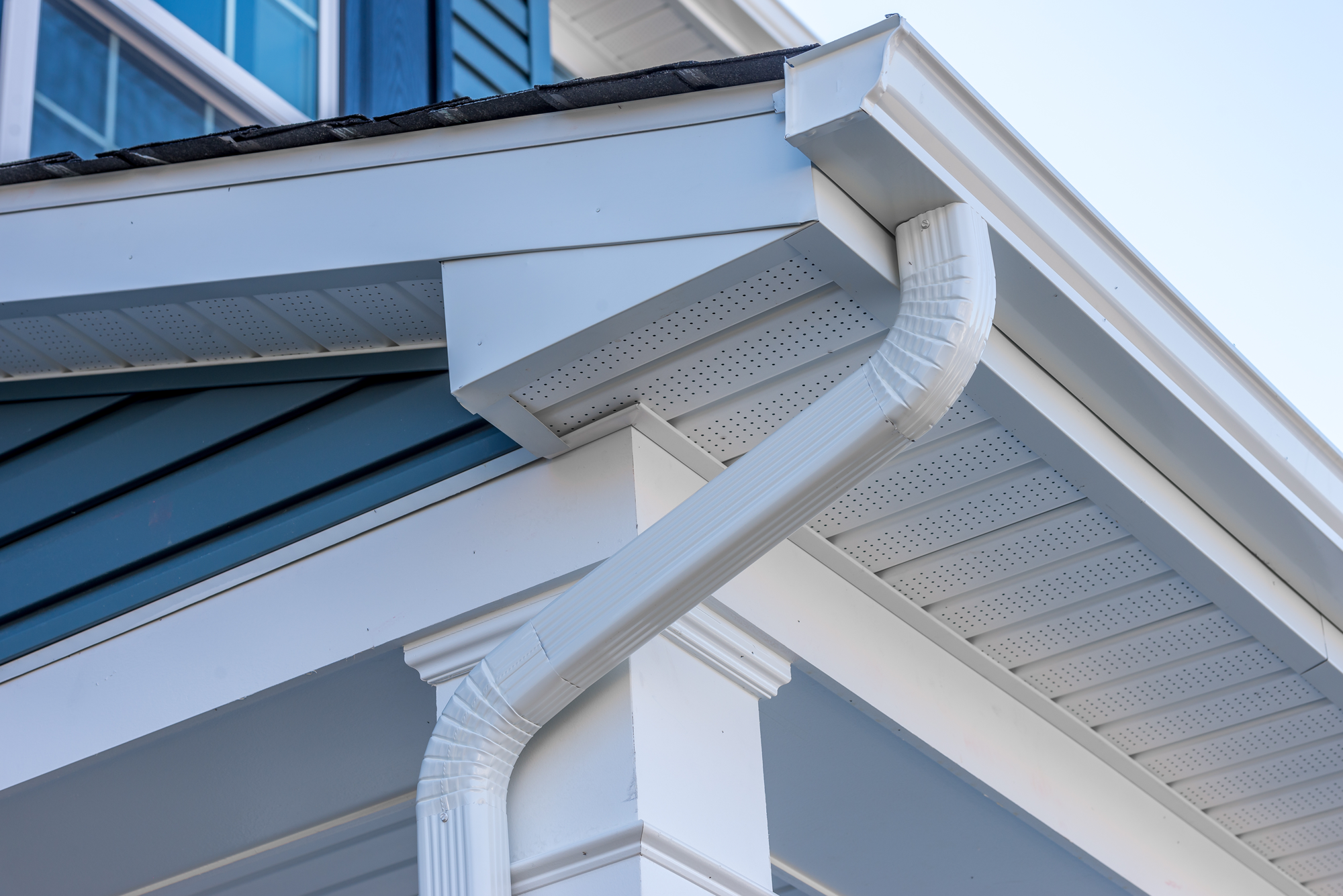 White gutters on blue sided house