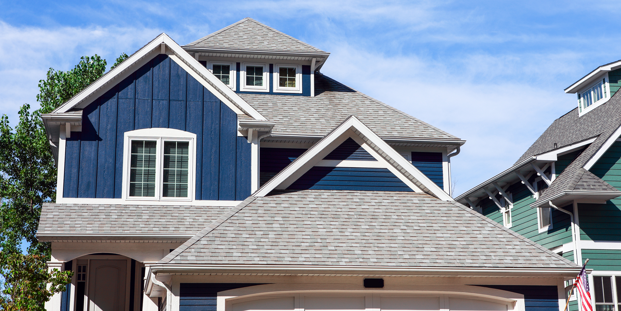 Blue house with grey shingle roof